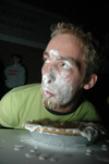Senior Nate Crew glances up at his competition while devouring an apple pie during the Fallapalooza pie eating contest. - Photo by Brad Moore