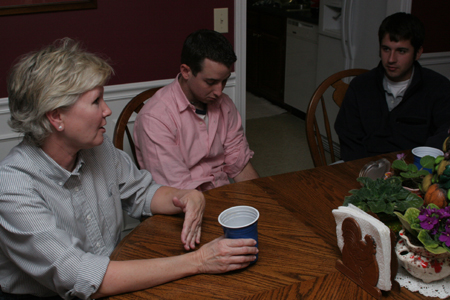 Pam Sutton, professor of English, enjoys some conversation with Senior Justin Belsly and Junior Stephen Goodin after a dinner in her home.