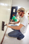 Junior John Kay and fellow Lambda Chi Alpha members cleaned walls at Whitehall Elementary during their Day of Remembrance work. - Photo by Kristen Nicole Sayres