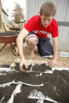 Sophomore Joe Cadden helped level and mulch space for a peace garden at Parkview Montessori during his Day of Remembrance service project. - Photo by Kristen Nicole Sayres