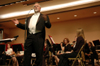 Conductor David McClune introduces a piece during a Symphonic Band performance. - Photo by Brad Moore
