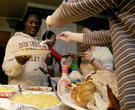 Purity Ogolla gets a second helping of turkey at the International Student Thanksgiving dinner hosted by Mario Cobo.
