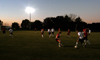 The men's soccer teams scrimmage on the new soccer field on a fall night. - Photo by Morris Abernathy