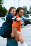 Nursing major Crystal Box gets a piggyback ride from her father during Family Weekend 2002.
 - Photo by Lindsay Stavish