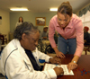 Stephanie Clark, career services secretary and events coordinator, spends time with patients at Mission Convalescent Home in Jackson on Martin Luther King, Jr. Day. - Photo by Morris Abernathy
