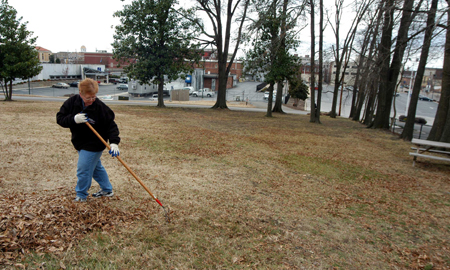 Phyllis Davenport, coordinator of campus events, rakes leaves at the Mission Convalescent Home in Jackson during Martin Luther King, Jr. Day.