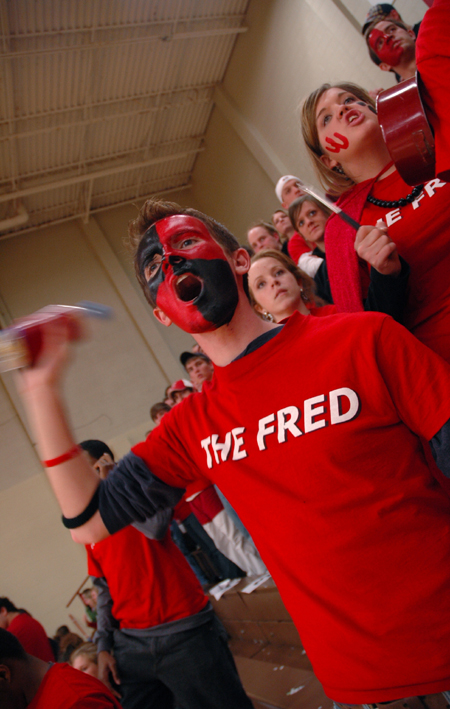A freshly-painted Matt Taylor leads the cheering section in <em>The Fred</em> during a Lady Bulldog game against Lambuth.