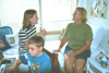 Freshman Jill Hickman shares some time with her family in her dorm room during Family Weekend 2002. - Photo by Lindsay Stavish