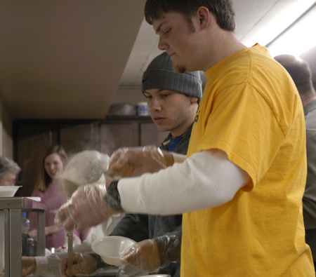 Andrew Smith and other college students at Poplar Heights Baptist Church serve at a fund raising event for an upcoming GO trip.