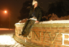 Freshman Emily Blackketter takes a rest on the Union sign after playing in the snow. - Photo by Heather Phillips