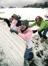 Brittany Sampson, Brian Burns, John Henson and Sarah Eastin take cover behind their makeshift fort during a snowball fight. - Photo by Kyle Kurlick