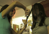 Kristmar Rawlins trims Kayli Anthony's hair in their dorm room. - Photo by Stephanny Rodriguez