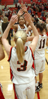 Union starters Crystal Eason (3) and Jennifer Henson (11) give high-fives to fellow starter Natanya Smith (32) during pregame introductions. - Photo by Brad Moore