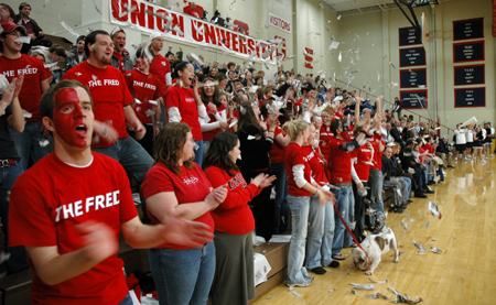 Students celebrate the first Union basket of the game with confetti and cheering.