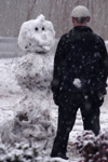 Brian Burns completes a snowman with personality. - Photo by Stephanny Rodriguez