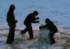 Jennifer May and the Herr boys destroy an old snowman outside of the McAfee commons. - Photo by Stephanny Rodriguez