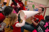 Senior Landon Preston demonstrates the use of a megaphone for the Thornbury girls. - Photo by Brad Moore