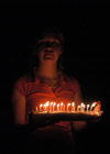 Katrina Parker brings in a flaming cake for Kristin Jenning's birthday. - Photo by Stephanny Rodriguez