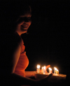 Katrina Parker brings in a flaming cake for Kristin Jenning's birthday. - Photo by Stephanny Rodriguez