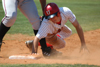 Junior outfielder Tyler Porter dives back into first base safely, but not before getting a hard tag in the ribs. - Photo by Steven Aldridge