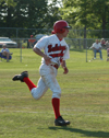 After a line drive single to center field, sophomore third baseman James Brasfield prepares to round first base. - Photo by Steven Aldridge