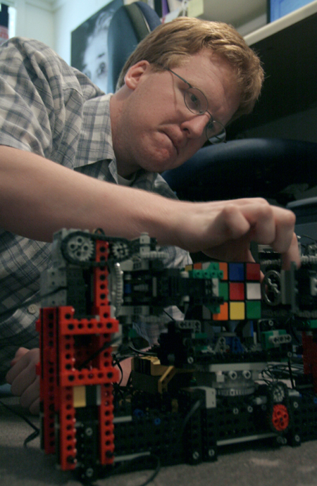Junior Kendal Hershberger works on programming his robot made of Lego parts. The goal of the robot is to grab, pick up and solve the Rubik's cube based on a pattern from a computer program.