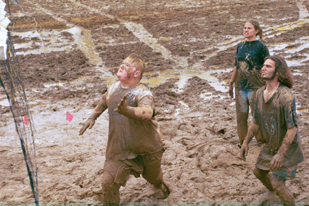 Freshman Jonathan Blair, Freshman Seth Massa, and Sopohomore Tiffany Windall await the ball for the next play in an intramural mud volleyball game.
