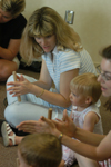 Kim Moody brings her daughter, Emma, to the Center every Tuesday. In addition to teaching
instruments and singing to the children's choir, teachers work with young students' dexterity. - Photo by Heather Phillips
