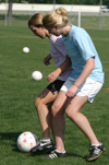 Emily Rawls (left) and Amy Anderson participate in two versus two drills during spring practice. - Photo by Heather Phillips