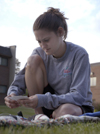 Junior Angela White spent some time studying for finals outside her dorm room in the McAfee complex. - Photo by Stephanny Rodriguez