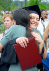 Cynthia Christine Keegan receives a big hug after the spring graduation ceremony. Keegan, from Murfreesboro, Tenn., received a bachelor of arts degree in art - Photo by Kyle Kurlick
