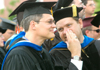 Department chairmen Gene Fant (right) of English and Troy Riggs (left) of mathematics share some conversation during the processional at spring graduation ceremonies on the Great Lawn. - Photo by Matthew Diggs