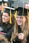 Katie Dratnol (right) of Ooltewah, Tenn. smiles after receiving a bachelor of science degree in special education. Dratnol won special education teacher of the year award and a medal for academic excellence. Megan Colleen Donnelly (left) of Edmond, Okla., received a bachelor of science degree in learning foundations. - Photo by Stephanie Schroeder