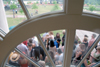Graduate friends and family wait for the end of a rain shower that shortened the graduation ceremony. - Photo by Tim Weisemann