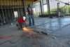 A worker prepares steel wall studs during the construction of White Hall. - Photo by Morris Abernathy