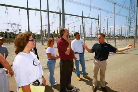 Wayne Wofford, center, led the environmental ethics class that was taught this past summer. Here students took a field trip to a local power plant.