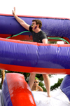 Brent Jones has fun getting wet and wild on a water slide during LXA's Bid Day. - Photo by Brad Moore