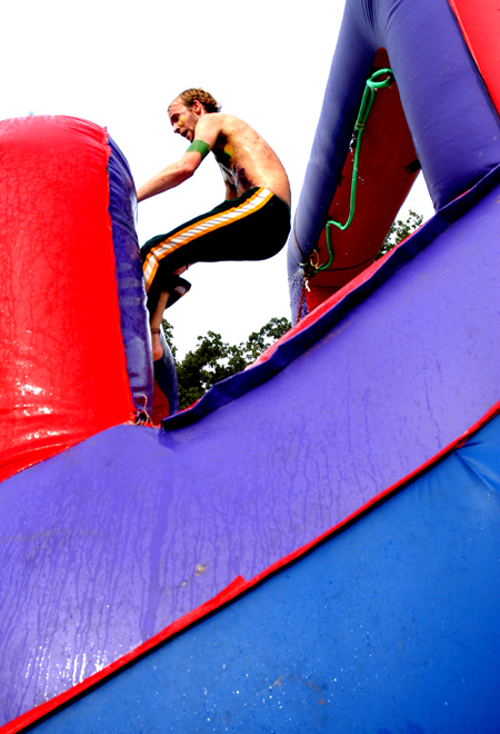 Junior John Kay goes airborne on a water slide during LXA's Bid Day.