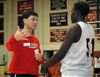 Mark Campbell, Head Coach of the Lady Bulldogs, gives direction to freshman center Josephine Owino. - Photo by Brad Moore