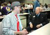 Sophomore Bob Cali, Biblical languages major, speaks with S. Truett Cathy, founder of Chick-Fil-A. Cathy spoke of the beginning of Chick-Fil-A and his journey of overcoming adversity to achieving his success. - Photo by Kristen Nicole Sayres