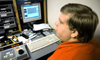 Josh Simmons demonstrates some of the technology in the control during a television production class. - Photo by Brad Moore
