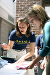 Gina Orosz helps Lauren Goley sign up for a door prize during Social Work Awareness Day. - Photo by Kyle Kurlick