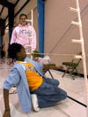 Mallory Keeton mans the limbo stick at the Jackson Boys & Girls Club during The Spring Fling. The Spring Fling was an activity where the Club and SASW collaborated to make a day of excitement for at-risk kids while giving student social workers experience. - Photo by Heather Phillips