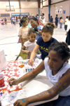 Gina Orosz mans a body painting station at the Jackson Boys & Girls Club during The Spring Fling. The Spring Fling was an activity where the Club and SASW collaborated to make a day of excitement for at-risk kids while giving student social workers experience. - Photo by Heather Phillips