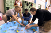 Jason Polk and Jonathon Russnoggle run a game in a swimming pool at the Jackson Boys & Girls Club during The Spring Fling. The Spring Fling was an activity where the Club and SASW collaborated to make a day of excitement for at-risk kids while giving student social workers experience. - Photo by Heather Phillips