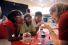 Sarah Conway talks with a group of girls before performing a chemistry demonstration at the Lincoln Elementary School for <em>Mathematics and Science in Jackson</em>. - Photo by Brad Moore