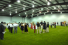 Visitors mingle in the turf room as part of the Fesmire Field House dedication ceremony Aug. 5. The 9,374-square foot room in the Fesmire Field House will allow for the baseball, softball and soccer teams to practice indoors.  - Photo by Morris Abernathy