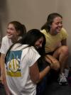 Natalie Morris, Courtney Bragg and Michelle Mangham enjoy a good laugh while joking around with other freshmen at the New Student Orientation open mic night. - Photo by Kyle Kurlick