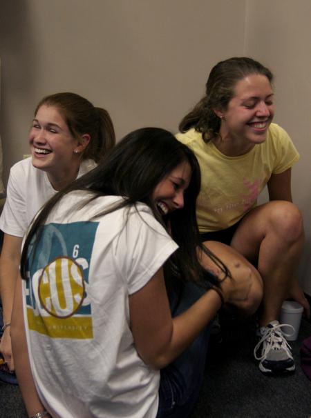Natalie Morris, Courtney Bragg and Michelle Mangham enjoy a good laugh while joking around with other freshmen at the New Student Orientation open mic night.