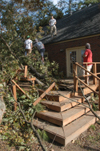 The SAEs worked on removing the large tree that fell on the back porch of their fraternity house on Saturday night as a result of the tornado. - Photo by Jim Veneman
